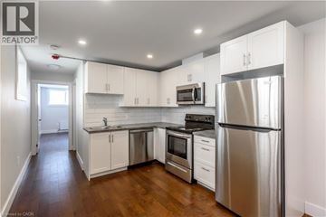 St. Catharines apartment for rent - A kitchen with white cabinets and stainless steel appliances.