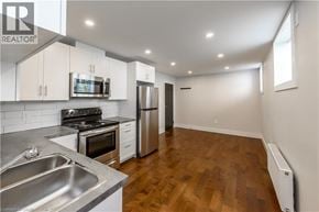 St. Catharines apartment for rent - A kitchen with a stove, oven, and refrigerator.