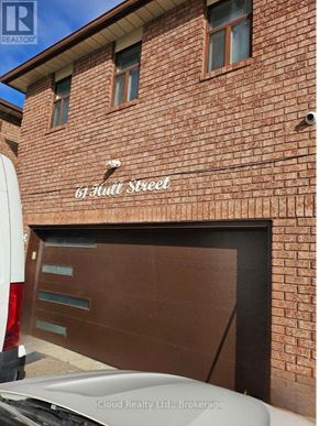 Mississauga (Malton) apartment for rent - A red brick building with a sign that says "6th Street" on it.