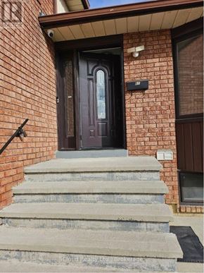 Mississauga (Malton) apartment for rent - A brown door is on a brick house.