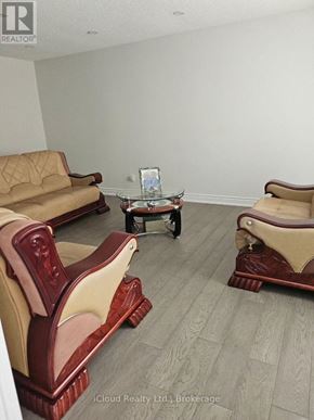 Mississauga (Malton) apartment for rent - A living room with a sofa, chair, and coffee table.