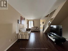 St. Catharines (E. Chester) apartment for rent - A living room with a striped couch and a television.