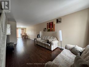 St. Catharines (E. Chester) apartment for rent - A living room with a striped couch and a lamp.