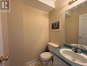 St. Catharines (E. Chester) apartment for rent - A bathroom with a toilet, sink and mirror.