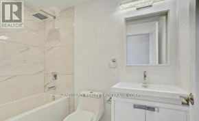 Toronto (Weston) multi-family for rent - A white bathroom with a tub, toilet, and sink.