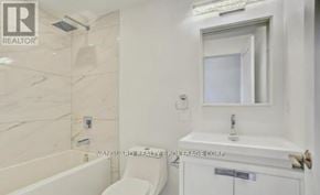 Toronto (Weston) multi-family for rent - A white bathroom with a tub, toilet, and sink.