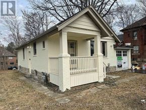 Mississauga (Mineola) multi-family for rent - A small white house with a porch is for sale.