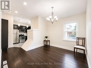 Mississauga (Mineola) multi-family for rent - A real estate listing photo of a kitchen and living room.