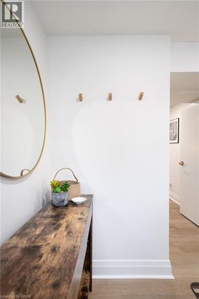 Hamilton apartment for rent - A long wooden table with a vase of flowers on it.