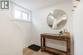 Hamilton apartment for rent - A wooden table with a mirror above it in a room.