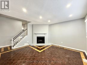 Ajax (Central) multi-family for rent - A living room with a fireplace and a staircase.