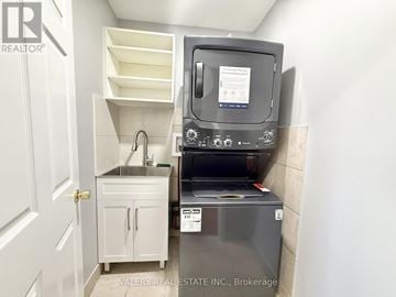 Ajax (Central) multi-family for rent - A small kitchen with a sink and a microwave.