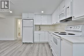 Richmond Hill (Crosby) apartment for rent - A white kitchen with Union Capital Realty logo.