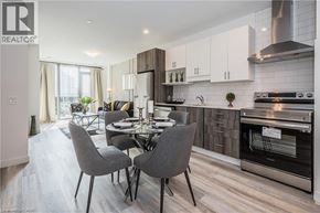 Kitchener condo for rent - A modern kitchen with a dining table set for four.