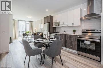 Kitchener condo for rent - A modern kitchen with a dining table set for four.