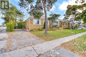 Oakville (Co Central) apartment for rent - A house with a driveway and a tree in front of it.