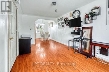 Oakville (Co Central) apartment for rent - A living room with wood floors and a television on the wall.