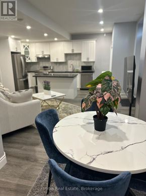 Oakville (Go Glenorchy) apartment for rent - A large, two-story house with a balcony and a black railing.