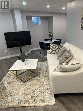 Oakville (Go Glenorchy) apartment for rent - A white bathroom with a toilet, sink, and mirror.