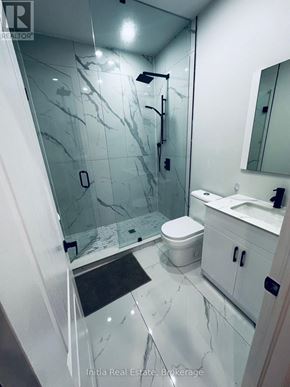 Oakville (Go Glenorchy) apartment for rent - A bathroom with a marble floor and white walls.