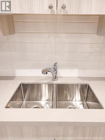 Toronto (Greenwood-Coxwell) duplex for rent - A modern kitchen with a double sink and a shelf above it.
