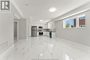 Windsor apartment for rent - A spacious kitchen with white marble flooring and modern appliances.