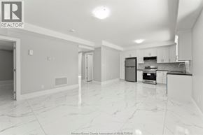 Windsor apartment for rent - A spacious kitchen with white marble flooring and modern appliances.