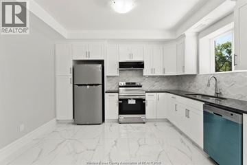 Windsor apartment for rent - A kitchen with white cabinets and a marble floor.