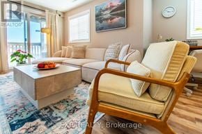 Barrie (Painswick South) townhouse for rent - A living room with a sofa, a coffee table, and a chair.