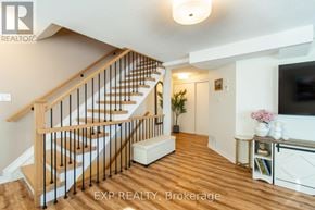 Barrie (Painswick South) townhouse for rent - A wooden staircase with a white railing and a light on the ceiling.
