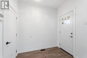 Hamilton (Stipley) apartment for rent - A white door is on the left and a white door with a window is on the right in a white room.