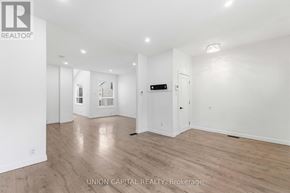 Hamilton (Stipley) apartment for rent - A spacious room with wooden flooring and white walls.