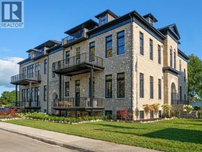 Amherstburg condo for rent - A large, multi-story building with a stone facade and balconies.