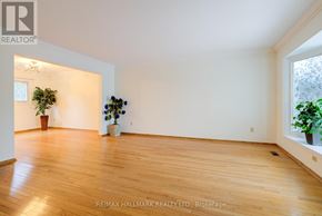 Toronto (L'amoreaux) apartment for rent - A room with wooden floors and white walls, with a plant in a pot on the left and a window on the right.