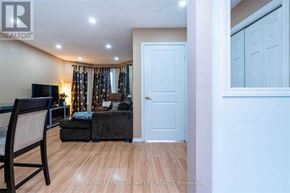 Brantford apartment for rent - A living room with a couch, chair, and a television.