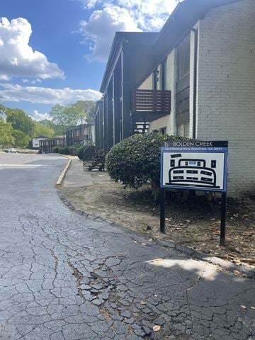 Forest Park apartment for rent - A sign for Bolden Creek stands in front of a building.
