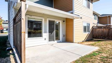 Saanichton apartment for rent - A house with a brown and white exterior and a brown fence.