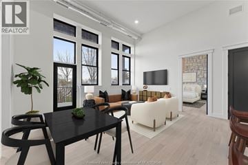 Amherstburg condo for rent - A modern living room with a black table and chairs.