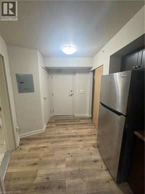 Kitchener apartment for rent - A long hallway with a refrigerator on the right.