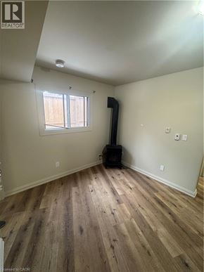 Kitchener apartment for rent - A room with wood flooring and a window.