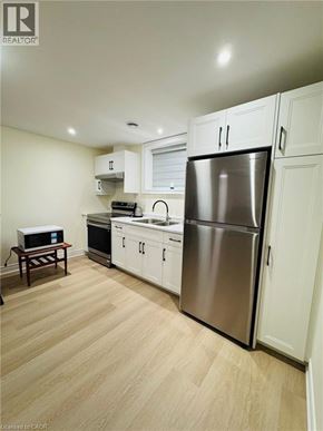Niagara Falls apartment for rent - A kitchen with a refrigerator, oven, and microwave.