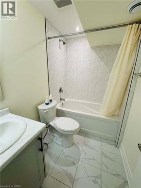Niagara Falls apartment for rent - A bathroom with a toilet, sink, and bathtub.