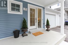 Wasaga Beach apartment for rent - A blue house with a white door and a number 35 on it.