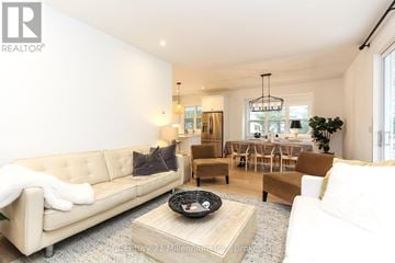 Wasaga Beach apartment for rent - A living room with a beige couch and a coffee table.
