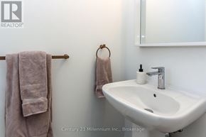 Wasaga Beach apartment for rent - A bathroom with a sink, towel rack, and mirror.