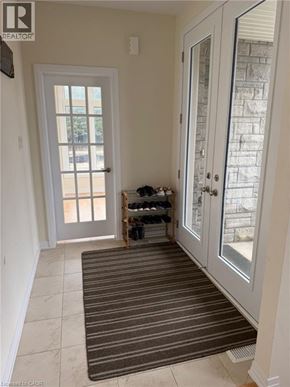 Binbrook apartment for rent - A room with a striped rug in front of a glass door.