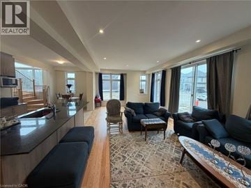 Binbrook apartment for rent - A living room with a black sofa and a wooden floor.