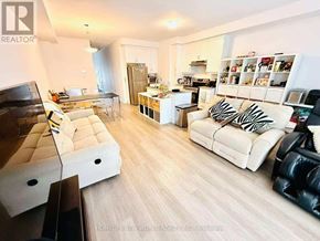 Markham (Middlefield) townhouse for rent - A living room with a white couch and a black chair.