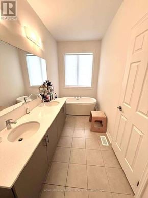 Markham (Middlefield) townhouse for rent - A bathroom with a sink, mirror, and tub.