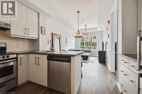 Grimsby condo for rent - A modern kitchen with white cabinets and stainless steel appliances.